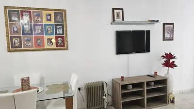 a living room with a table and a tv at STAY Alex's House in Strovolos