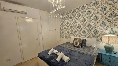 a bedroom with a bed with two towels on it at STAY Alex's House in Strovolos