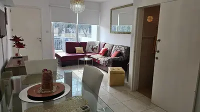a living room with a table and a couch at STAY Alex's House in Strovolos