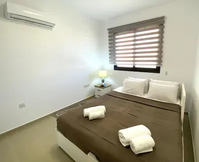 a bedroom with a large bed with two white pillows at Kyklades Resort & Spa in Paralimni