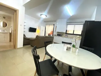 a kitchen and living room with a table and chairs at Kyklades Resort & Spa in Paralimni