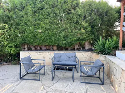 three chairs and a table on a patio at Charming Erimi Villa with Private Pool and Garden View in Erimi