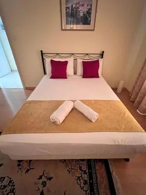 a bedroom with a bed with two pillows on it at Charming Erimi Villa with Private Pool and Garden View in Erimi