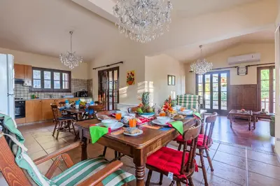 a kitchen and dining room with a table and chairs at Villa Penelope Platres in Kato Platres