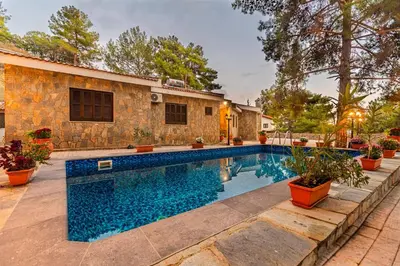a swimming pool in the backyard of a house at Villa Penelope Platres in Kato Platres