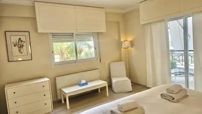 a bedroom with a bed and a table and a chair at STAY Charm Classic Apartment in Strovolos