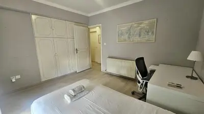 a bedroom with a bed and a desk and a chair at STAY Charm Classic Apartment in Strovolos