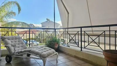 a chair sitting on top of a balcony at STAY Charm Classic Apartment in Strovolos