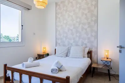 a bedroom with two beds and a window at Yellow Canvas - 2-BR Apartment & Balcony in Larnaca in Larnaka