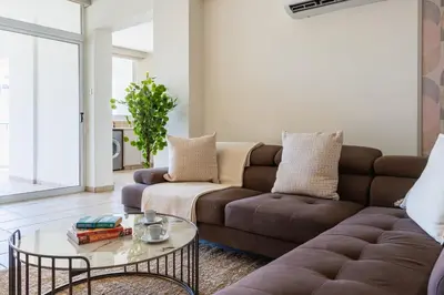 a living room with a couch and a table at Yellow Canvas - 2-BR Apartment & Balcony in Larnaca in Larnaka