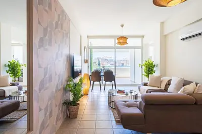 a living room with couches and a dining room at Yellow Canvas - 2-BR Apartment & Balcony in Larnaca in Larnaka