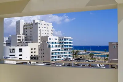 a view of a city with tall buildings and the ocean at Downtown Sea View Penthouse in Larnaka
