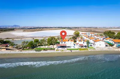 an aerial view of a beach with a red marker at Shoreline Beach House in Larnaka