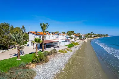 an aerial view of a house next to the ocean at Shoreline Beach House in Larnaka