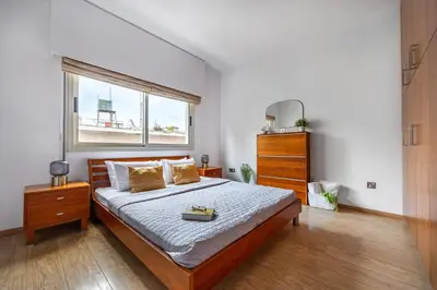a bedroom with a large bed and a window at Lena Court - Spacious 3bdr, City Views in Limassol