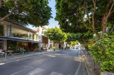 an empty street with trees and tables and buildings at Lena Court - Spacious 3bdr, City Views in Limassol
