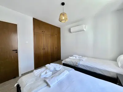 a bedroom with two beds with towels on them at STAY Paradise Apartment in Protaras