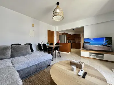 a living room with a couch and a table at STAY Paradise Apartment in Protaras