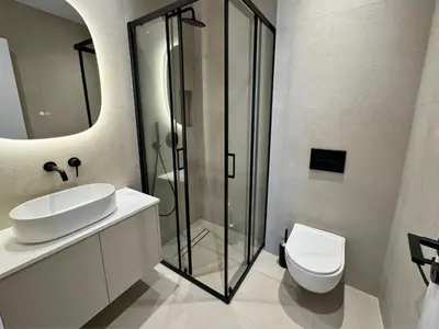 a bathroom with a sink and a shower and a toilet at Hypnos Park View in Nicosia