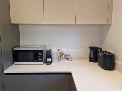 a kitchen counter with a microwave on top of it at Hypnos Park View in Nicosia