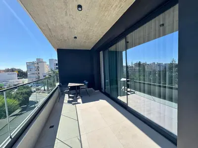 an apartment balcony with a view of the city at Hypnos Park View in Nicosia