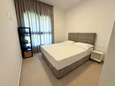 a bedroom with a large bed and a large window at Hypnos Park View in Nicosia