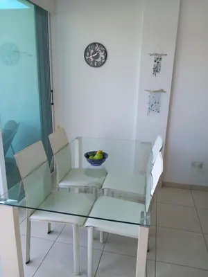 a glass table and chairs in a room at Casa Luna in Paralimni