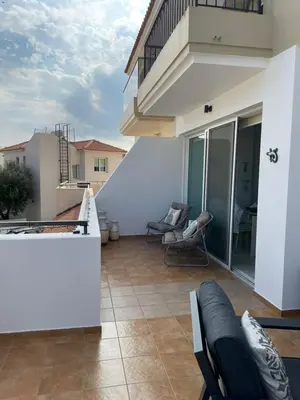 a balcony of a house with chairs and a balcony at Casa Luna in Paralimni