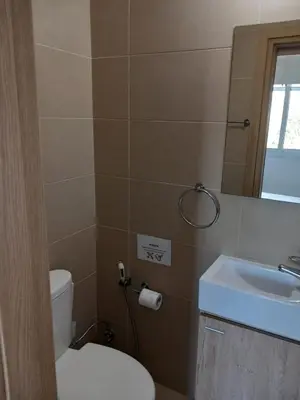 a bathroom with a toilet and a sink and a mirror at Casa Luna in Paralimni