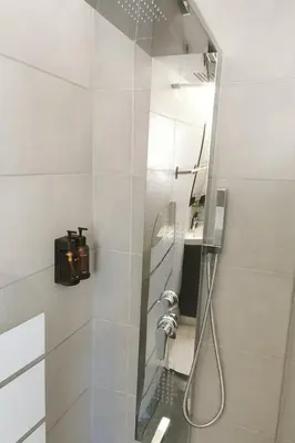 a white bathroom with a shower with a glass door at Alasia Apt-2Bdr in Nicosia