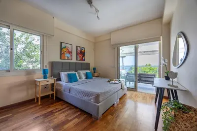 a bedroom with a bed with blue pillows at Berengaria Court - Sea Views 2bdr Apartment in Limassol