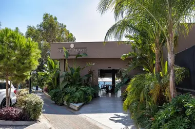 a building with palm trees in front of it at Berengaria Court - Sea Views 2bdr Apartment in Limassol