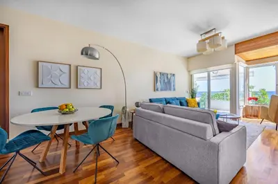 a living room with a couch and a table and chairs at Berengaria Court - Sea Views 2bdr Apartment in Limassol