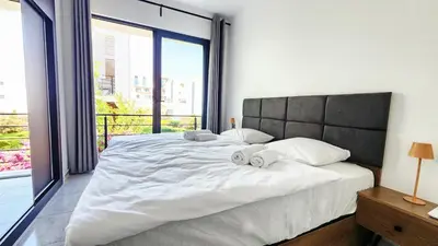 a bedroom with a large bed with two towels on it at Idyll Homes THE PENTHOUSE in Avdhelleron