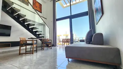 a bedroom with a bed and a table and chairs at Idyll Homes THE PENTHOUSE in Avdhelleron