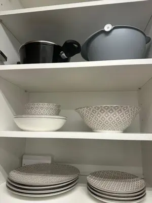 a shelf with plates and a pot and bowls at Idei-Eos Charming & Comfort Apartment in Nicosia