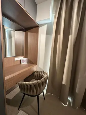 a dressing room with a chair and a mirror at Idei-Eos Charming & Comfort Apartment in Nicosia