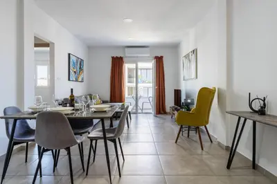 a dining room with a table and chairs at Hilltop 2-Bedroom Apartment in Larnaka