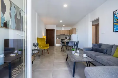 a living room with a couch and a table at Hilltop 2-Bedroom Apartment in Larnaka