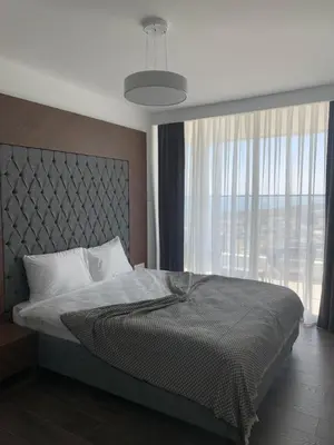 a bedroom with a bed and a large window at Grand Shapphire 4 apartments SEA VIEW in Paralimni