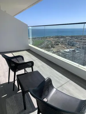 two chairs and a table on a balcony with a view at Grand Shapphire 4 apartments SEA VIEW in Paralimni