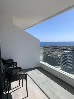 a room with two chairs and a large window at Grand Shapphire 4 apartments SEA VIEW in Paralimni