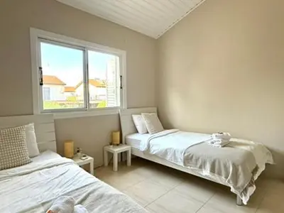 a bedroom with two beds and a window at Onyx Beach Villa - Cozy 2BR - Walk to Beach in Meneou