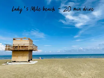 a lifeguard tower on a beach with the words lady mile beach man at Calypso Historic Village House in Limassol