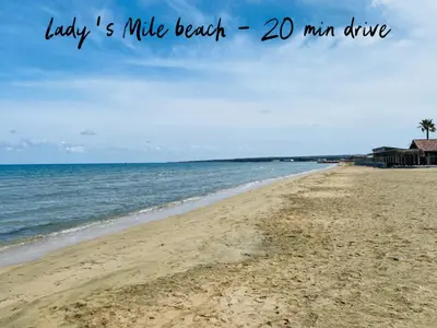 a beach with the words lady mile beach min drive at Calypso Historic Village House in Limassol