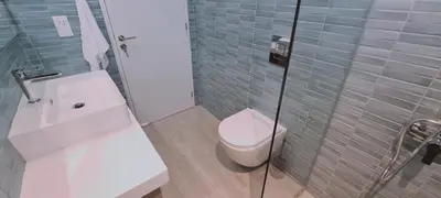 a bathroom with a toilet and a sink and a shower at Amalfi Suite at Mythical Sands Resort in Paralimni
