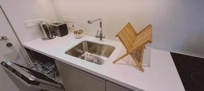 a kitchen counter with a sink in a kitchen at Amalfi Suite at Mythical Sands Resort in Paralimni