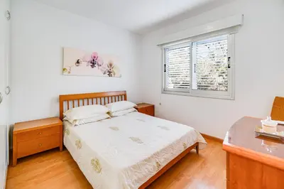 a bedroom with a bed and a window at Family Friendly 2-Bed on Limassol Seafront in Limassol
