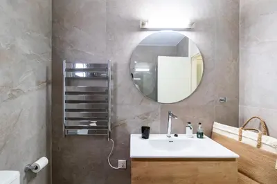 a bathroom with a sink and a mirror at Family Friendly 2-Bed on Limassol Seafront in Limassol