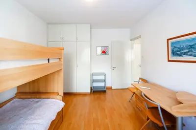 a bedroom with a bunk bed and a desk at Family Friendly 2-Bed on Limassol Seafront in Limassol